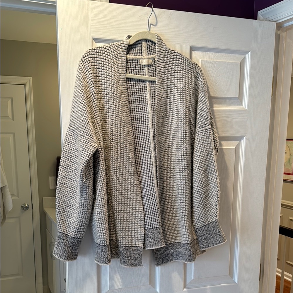 White & grey sleeping on snow sweater
